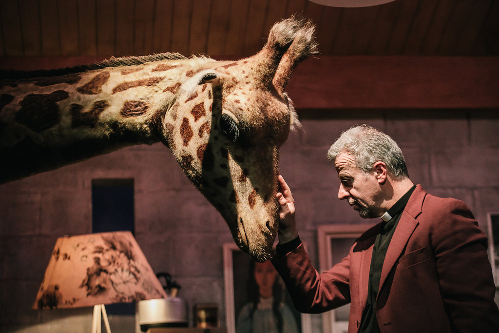 Carl Bland as Rev Sedgwick with Giraffe
