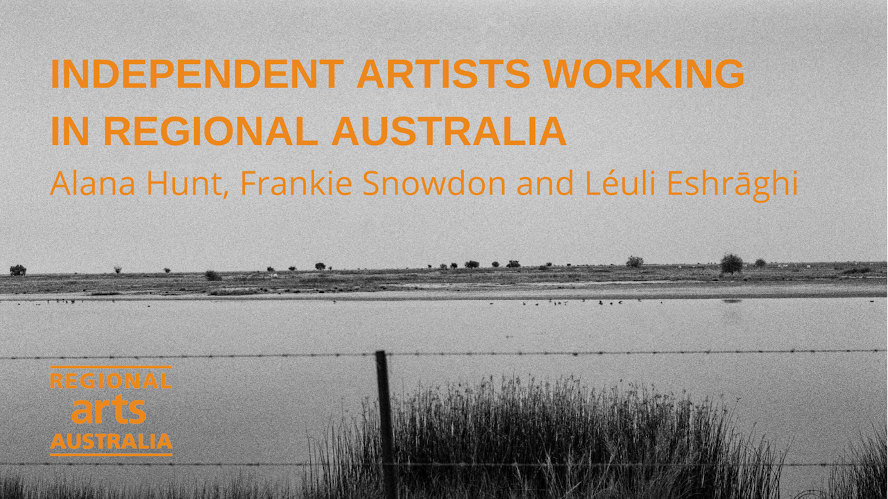 Black and white photo of a lake with land in the background with some plants. In front is a wire fence. Text on photo says "Independent Artists working in Regional Australia. Alana Hunt, Frankie Snowdon and Leuli Eshraghi. Regional Arts Australia.